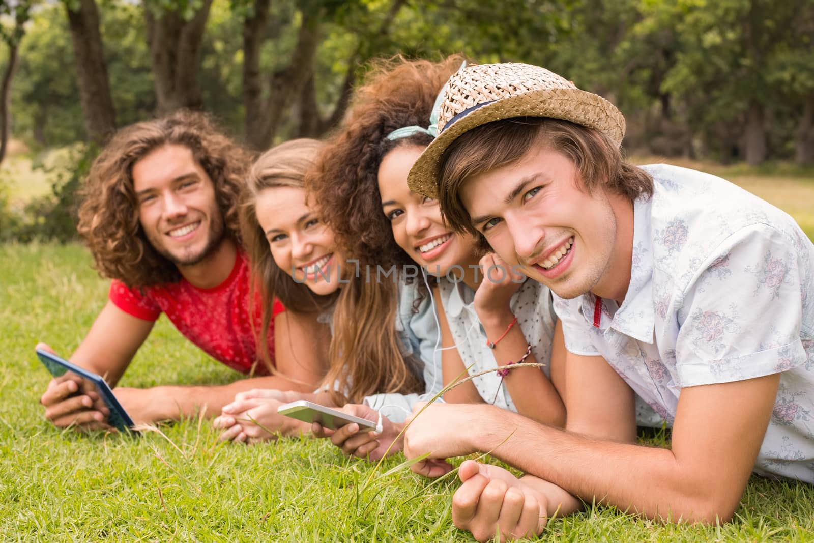 Happy friends in the park by Wavebreakmedia