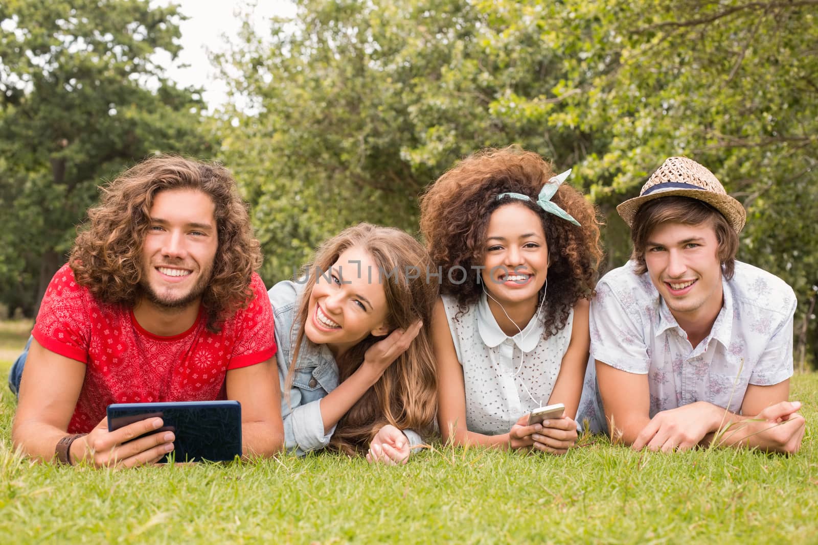 Happy friends in the park by Wavebreakmedia