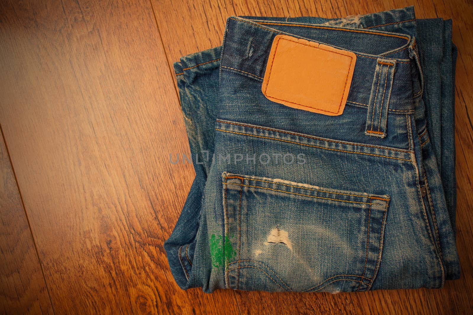old blue jeans with brown label on the belt smeared with green p by Astroid