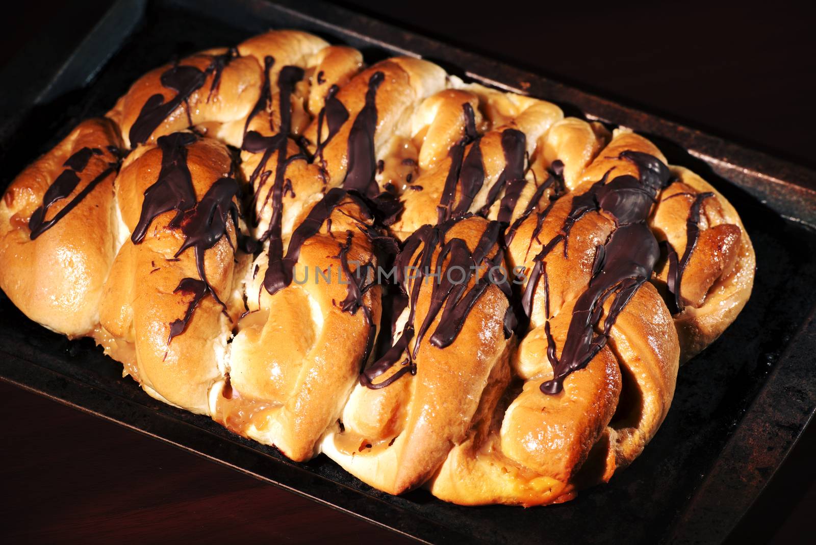 Chocolate and caramel danish pastry on a baking tray