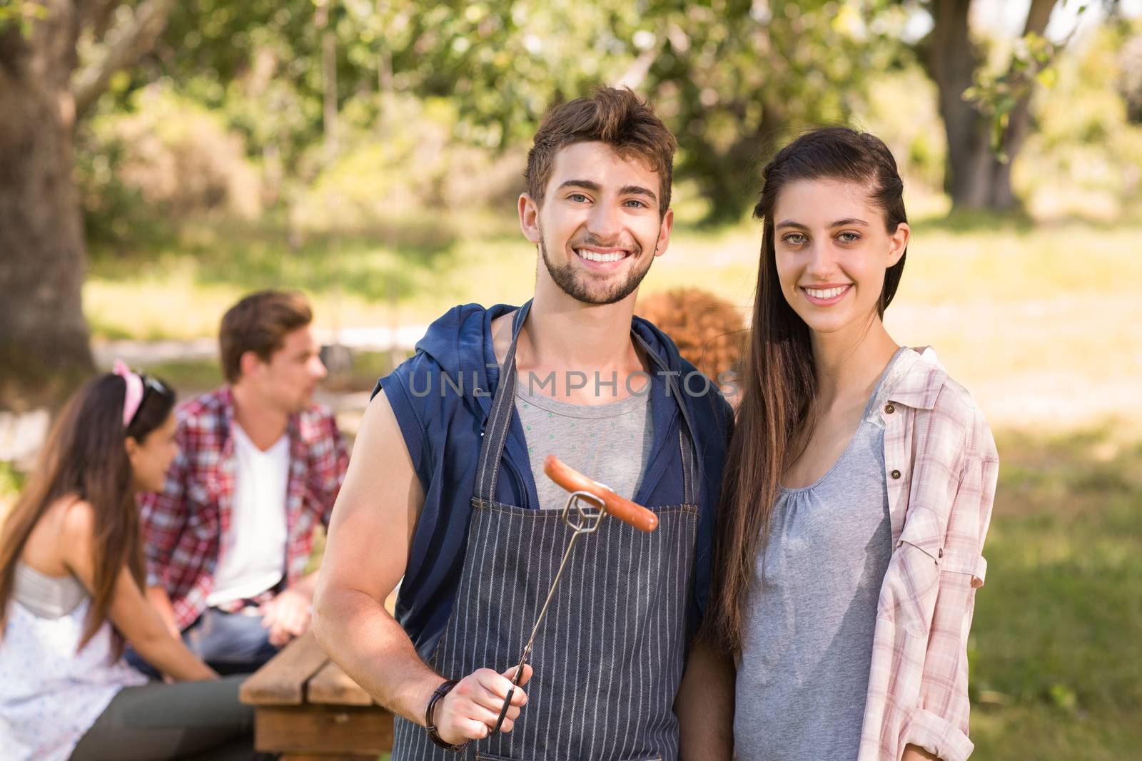 Happy friends in the park having barbecue by Wavebreakmedia