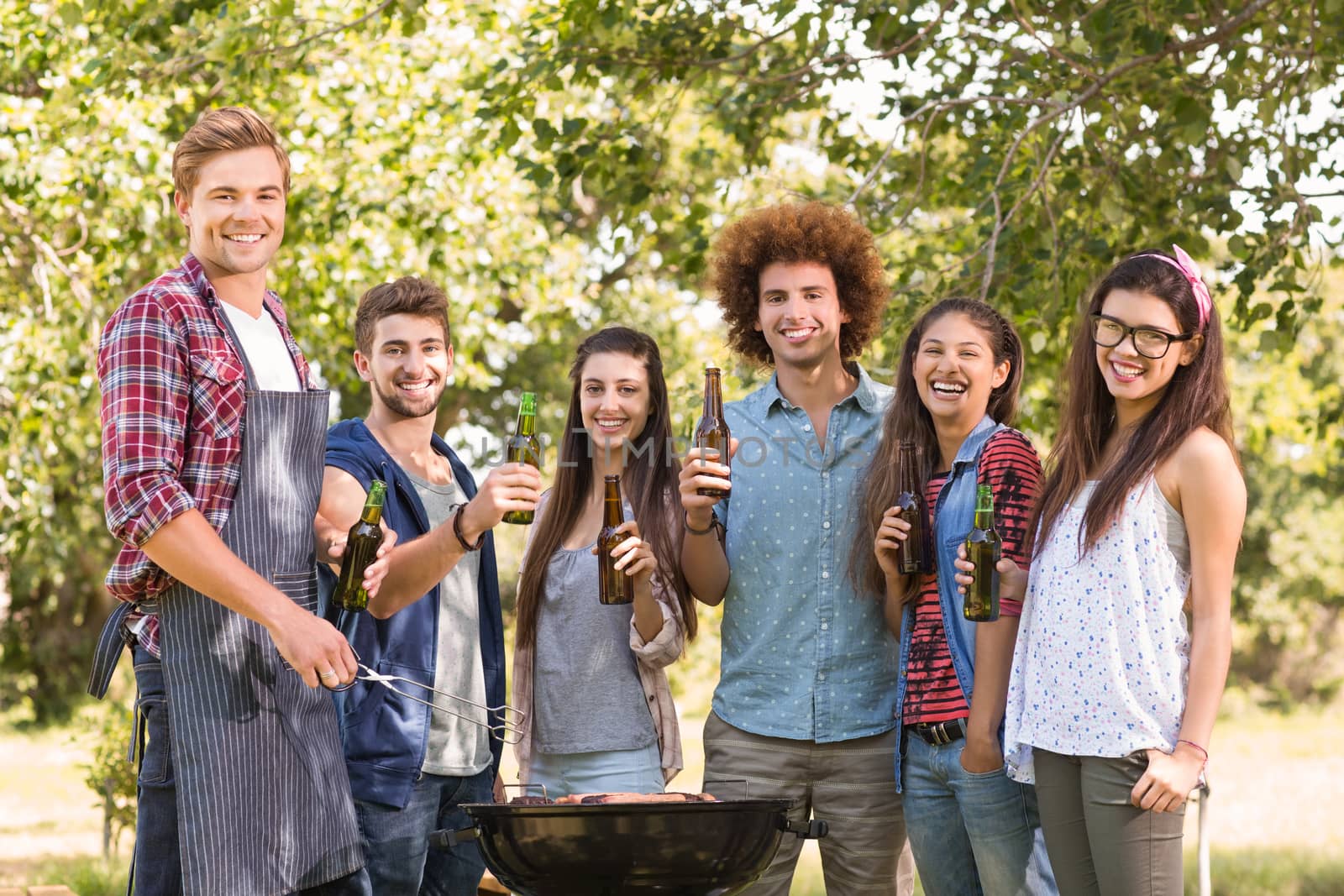 Happy friends in the park having barbecue by Wavebreakmedia