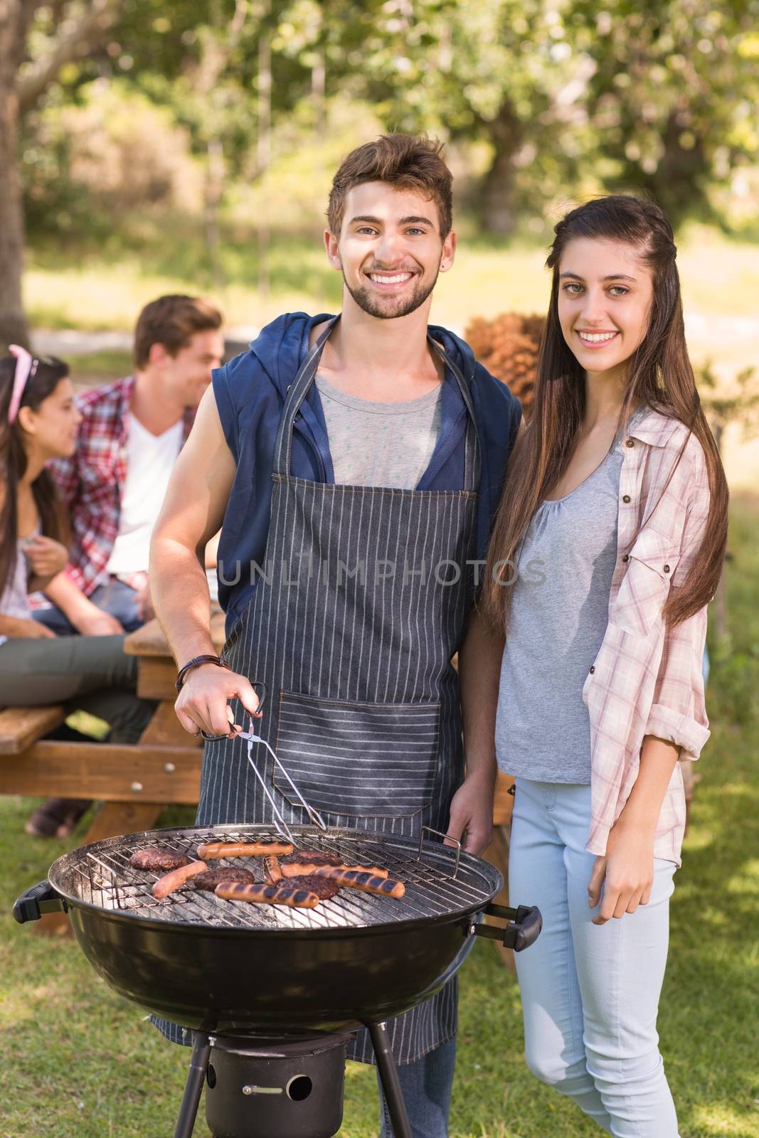 Happy friends in the park having barbecue by Wavebreakmedia