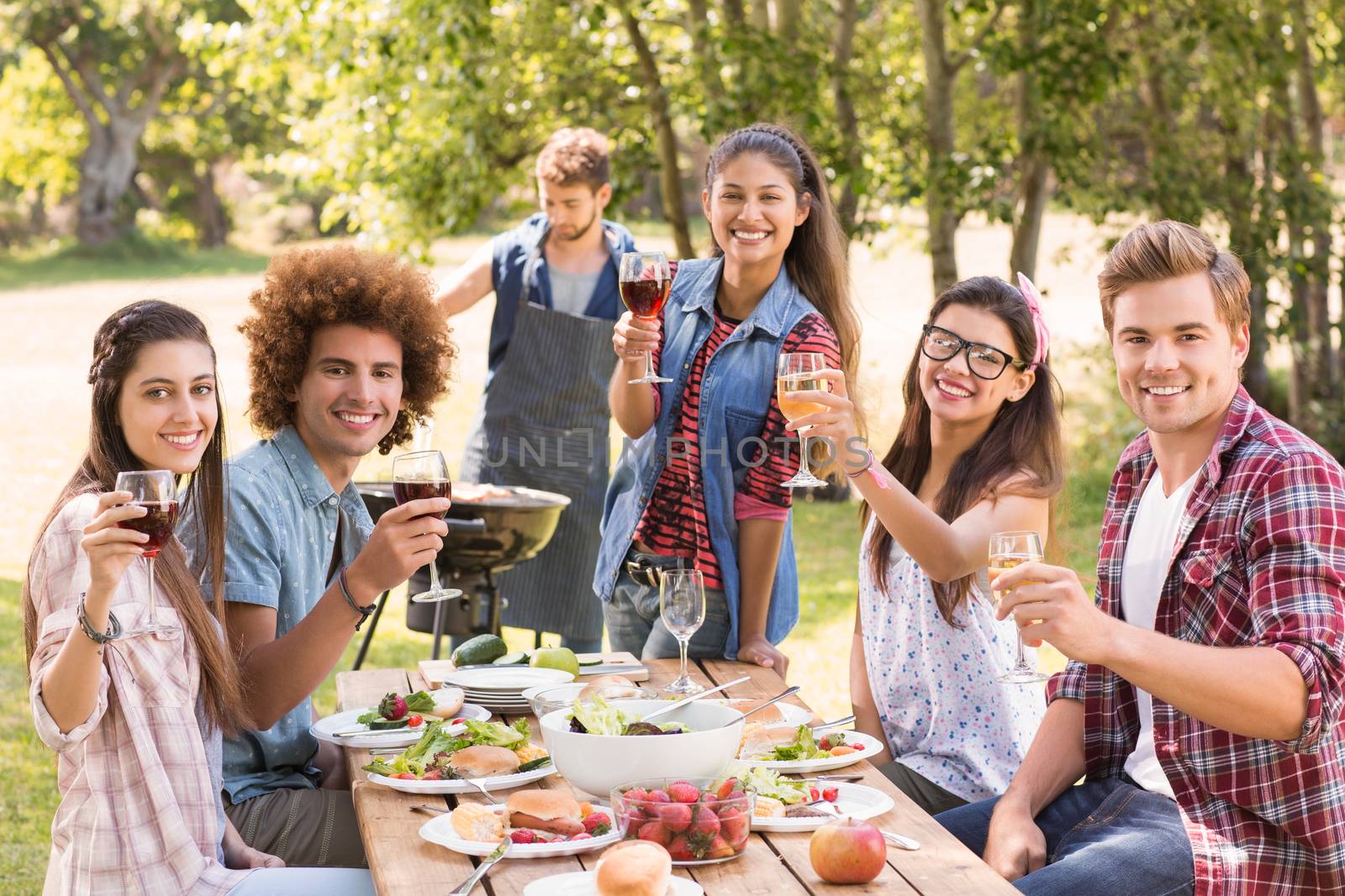 Happy friends in the park having lunch by Wavebreakmedia