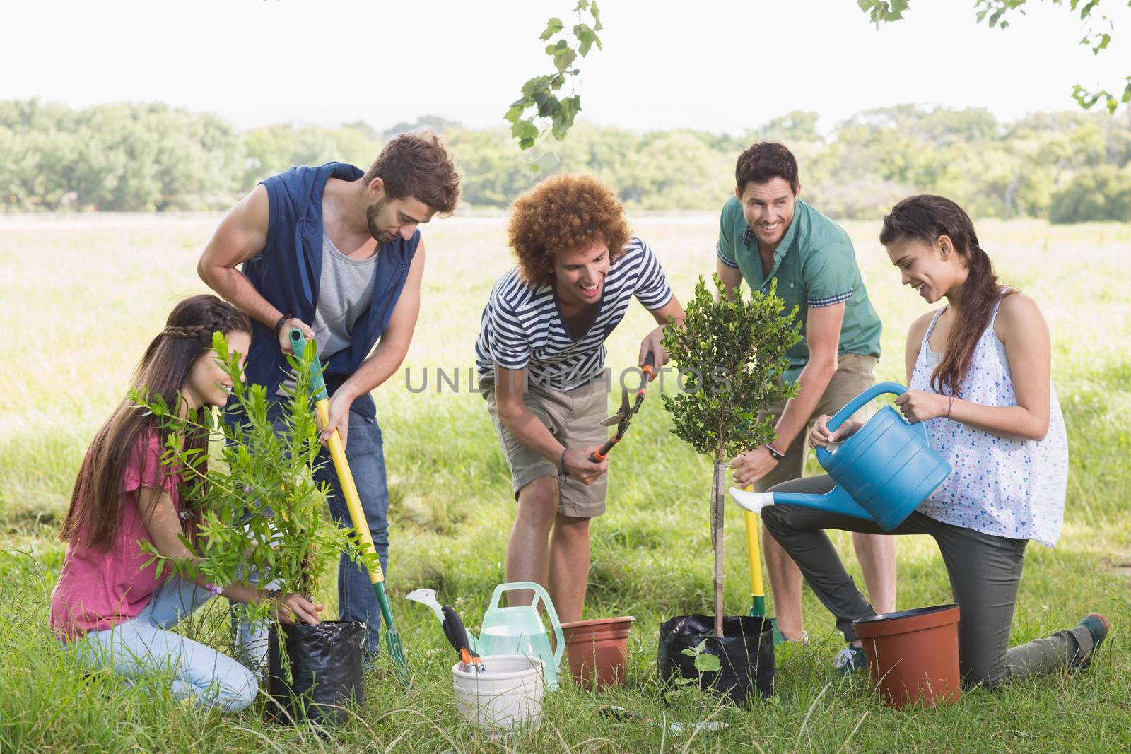 Happy friends gardening for the community on a sunny day