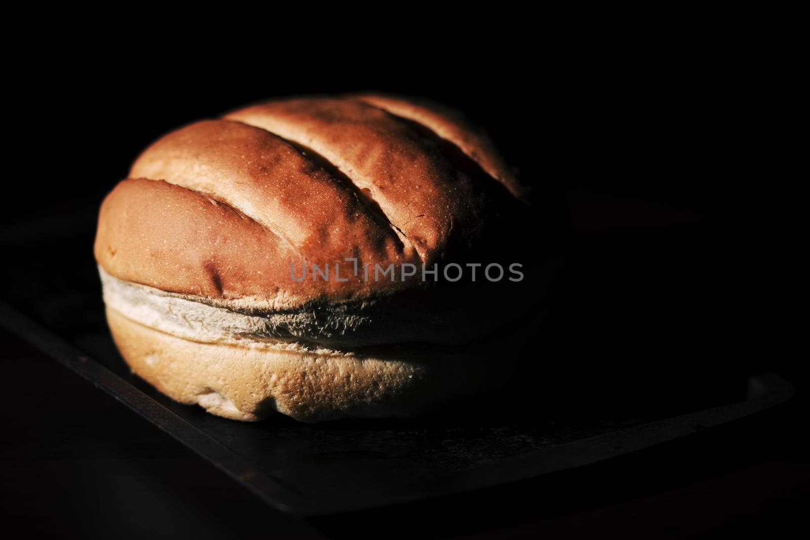 Round loaf of bread on a baking tray