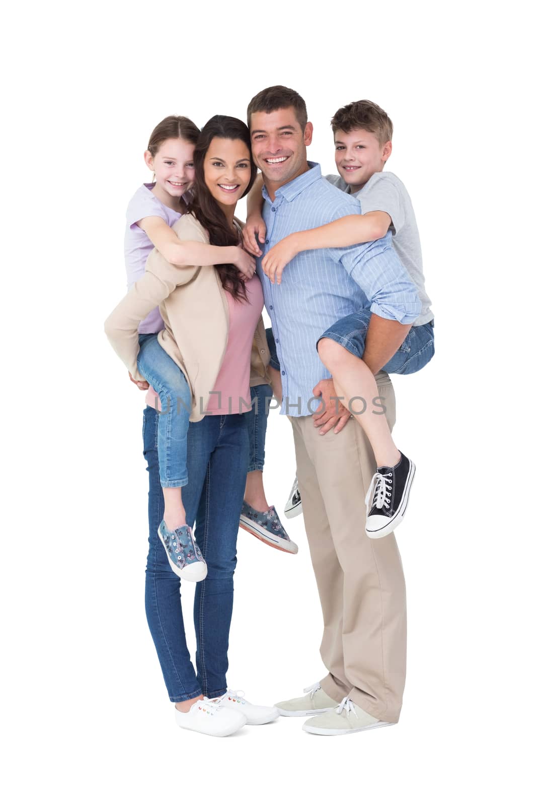 Full length portrait of parents giving piggyback ride to children over white background