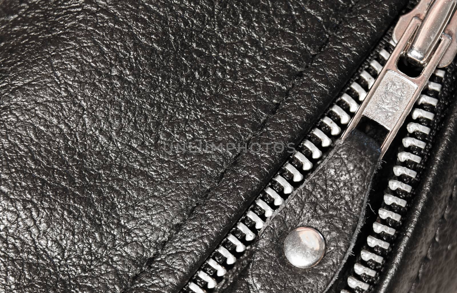 Part black leather clothing with a zipper. macro photo