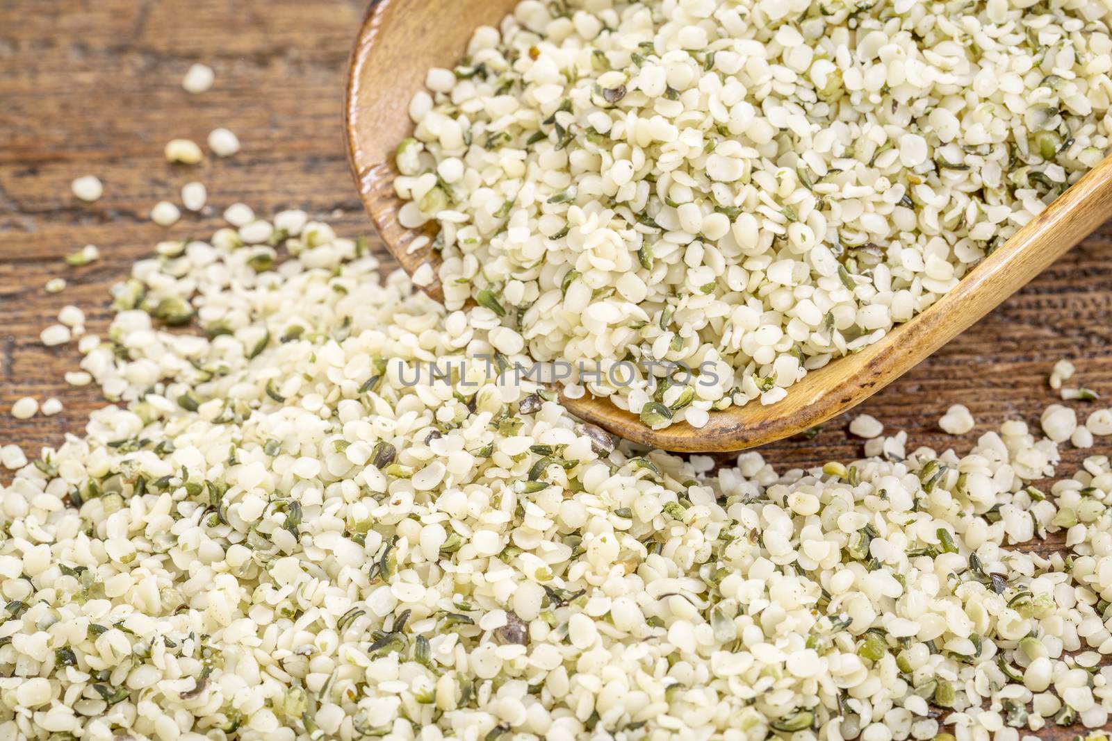 shelled hemp seed (hearts) on a wooden rustic scoop