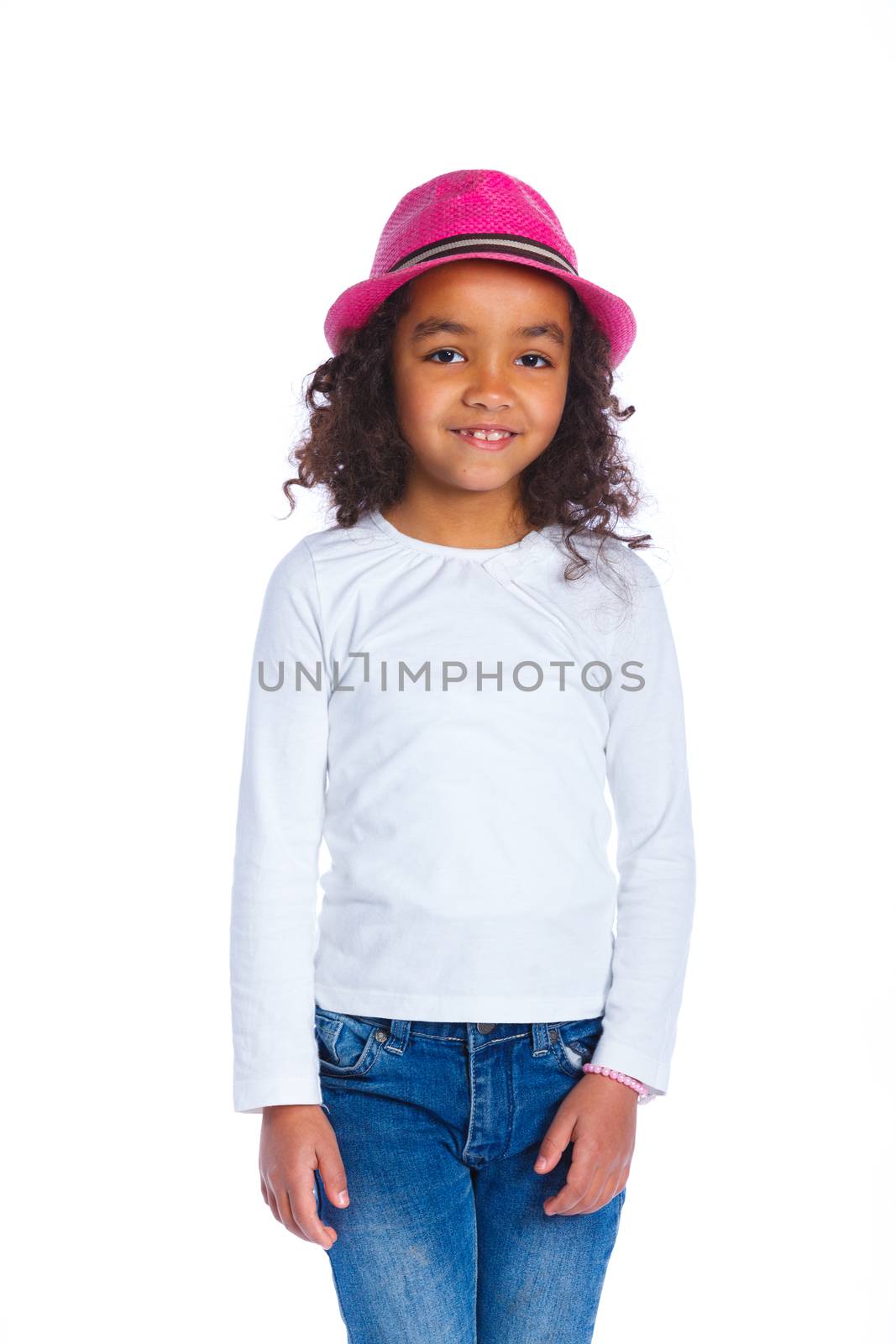 Portrait of a pretty mulatto girl in pink hat smiling at camera on white background