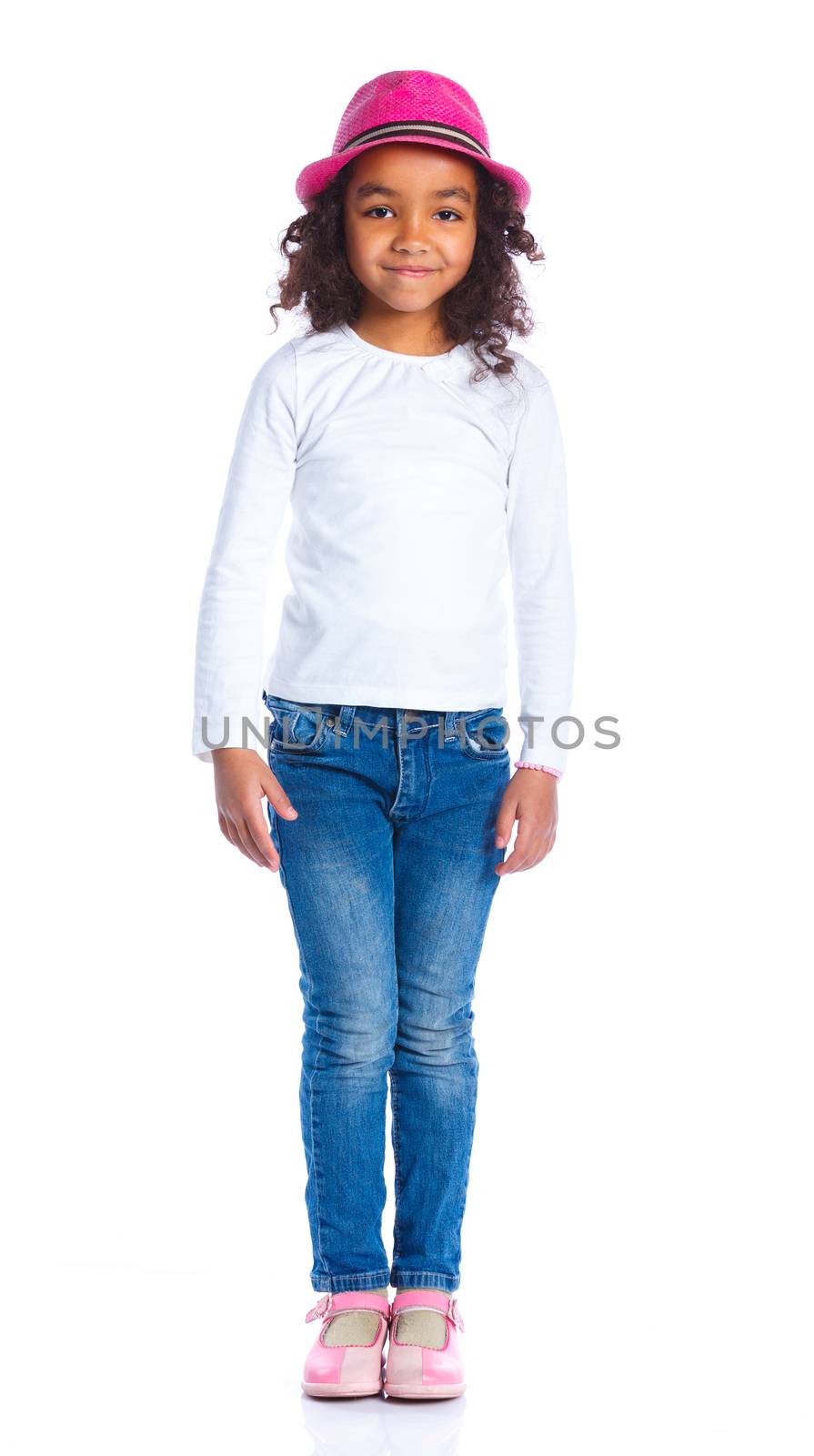 Pretty mulatto girl in pink hat smiling at camera on white background