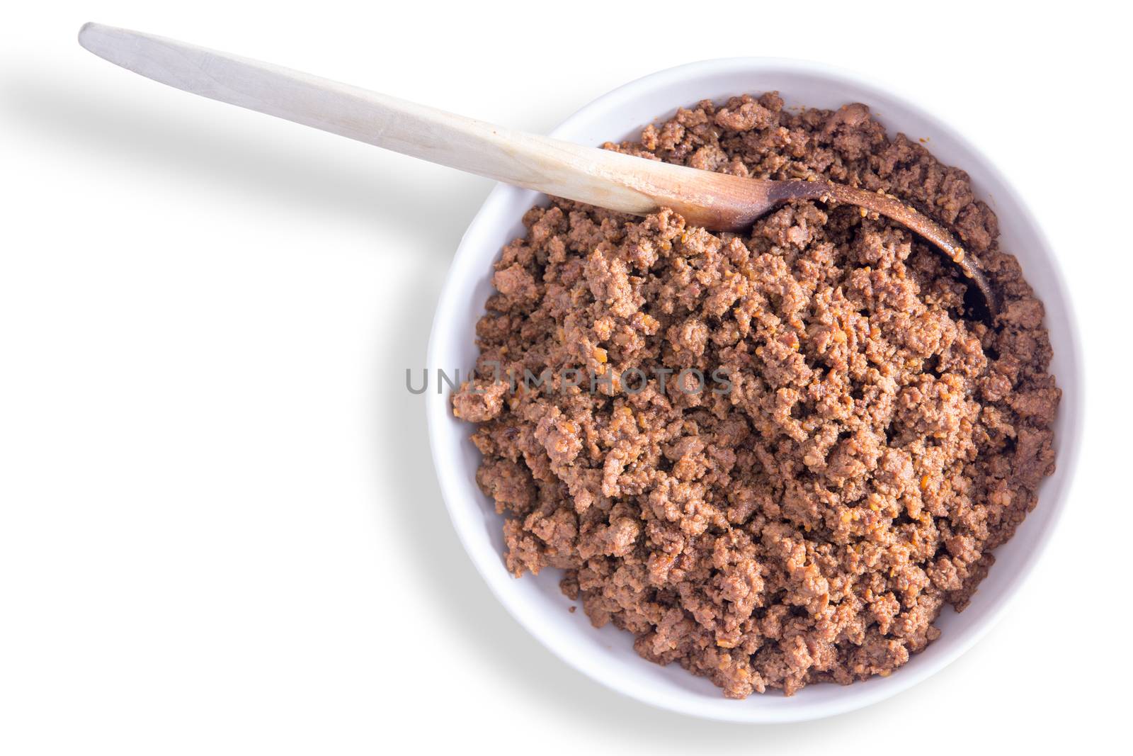 Bowl of freshly prepared savory ground or minced beef mixture for filling tortillas or tacos with a wooden spoon on a white background with copyspace, overhead view