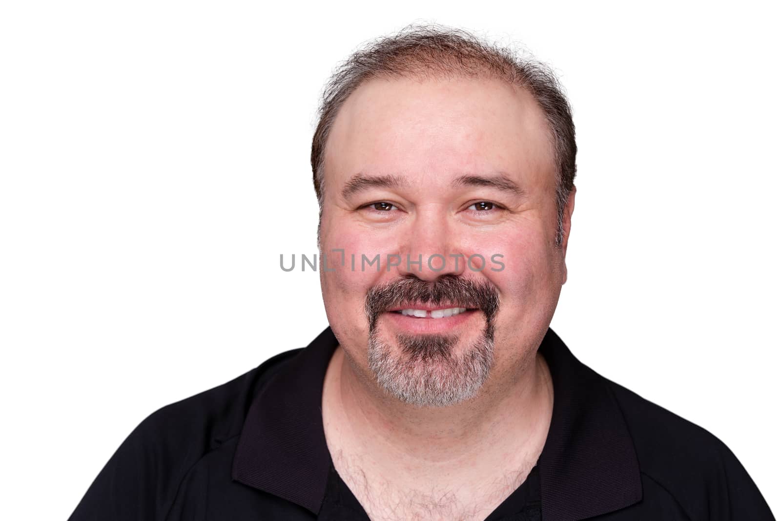 Smiling happy middle-aged man with a goatee beard looking at the camera with a warm friendly smile, isolated on white