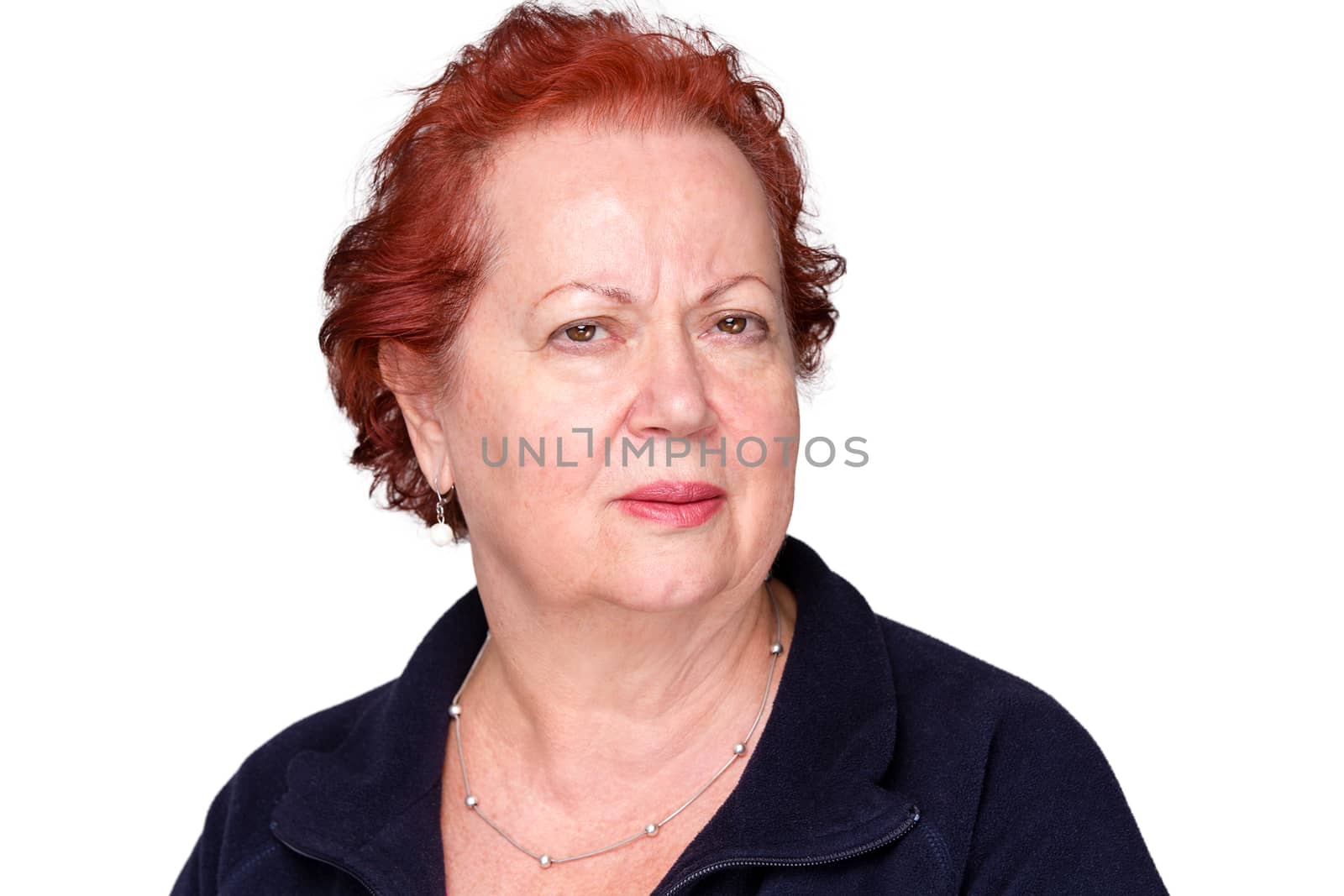 Perplexed senior lady with a puzzled frown staring intently at the camera with an unconvinced expression, isolated on white
