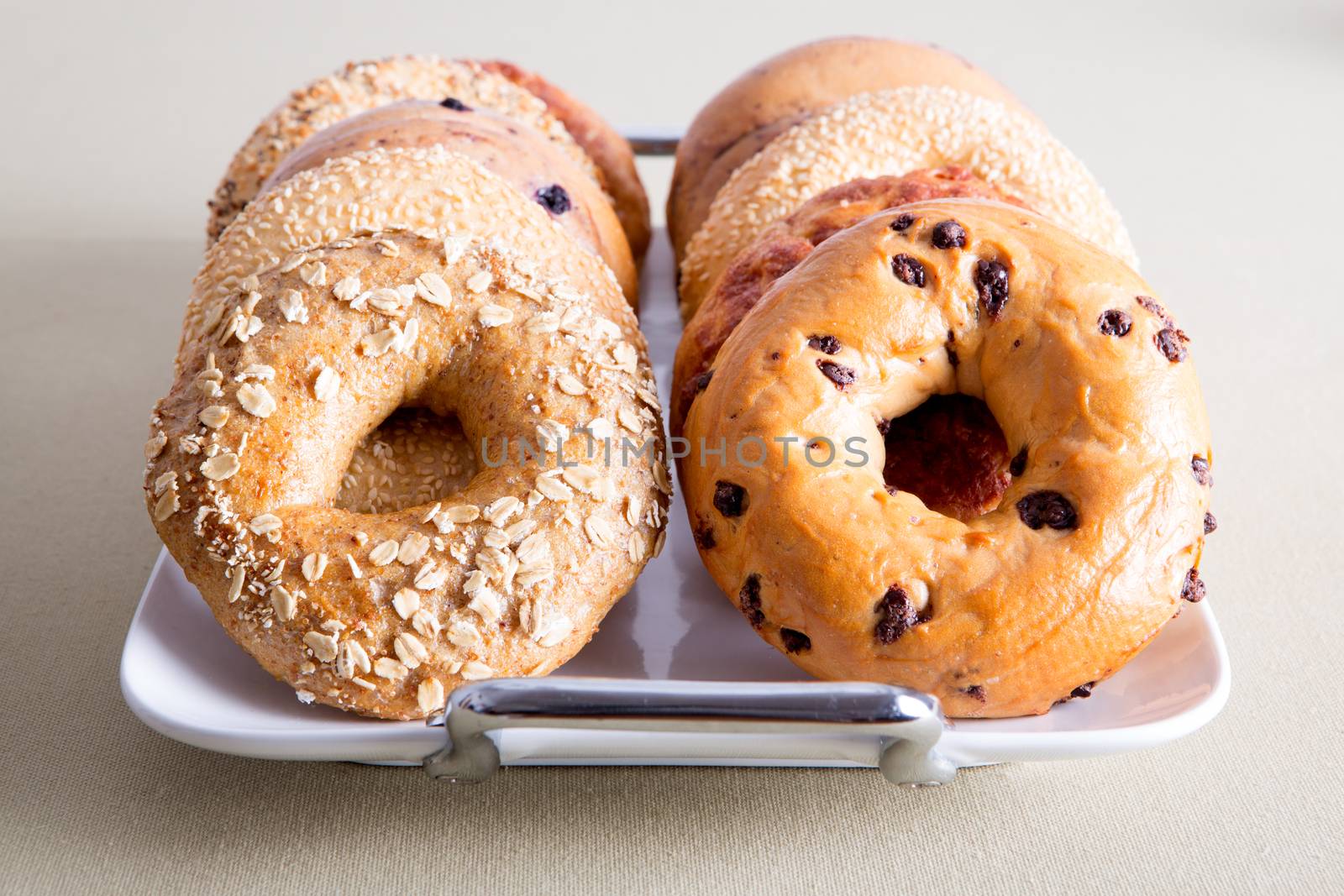 Close up Delicious Bagel Breads on White Tray by coskun