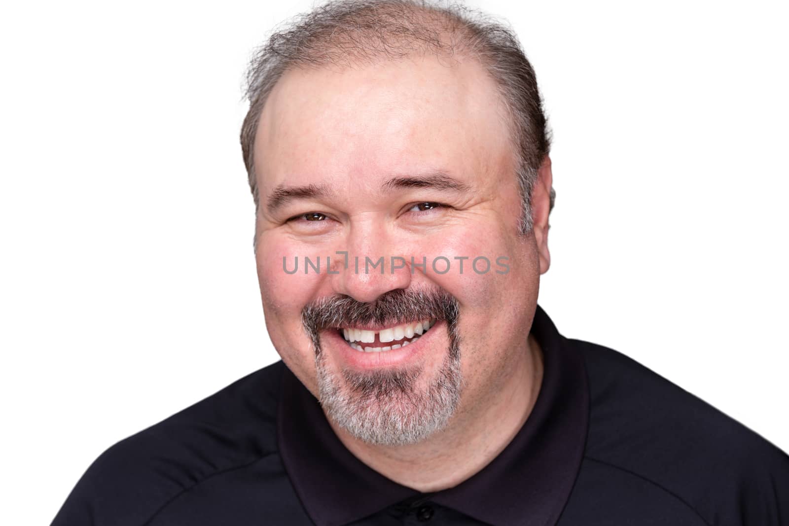 Happy relaxed smiling middle-aged man looking at the camera with a lovely wide friendly smile, isolated on white