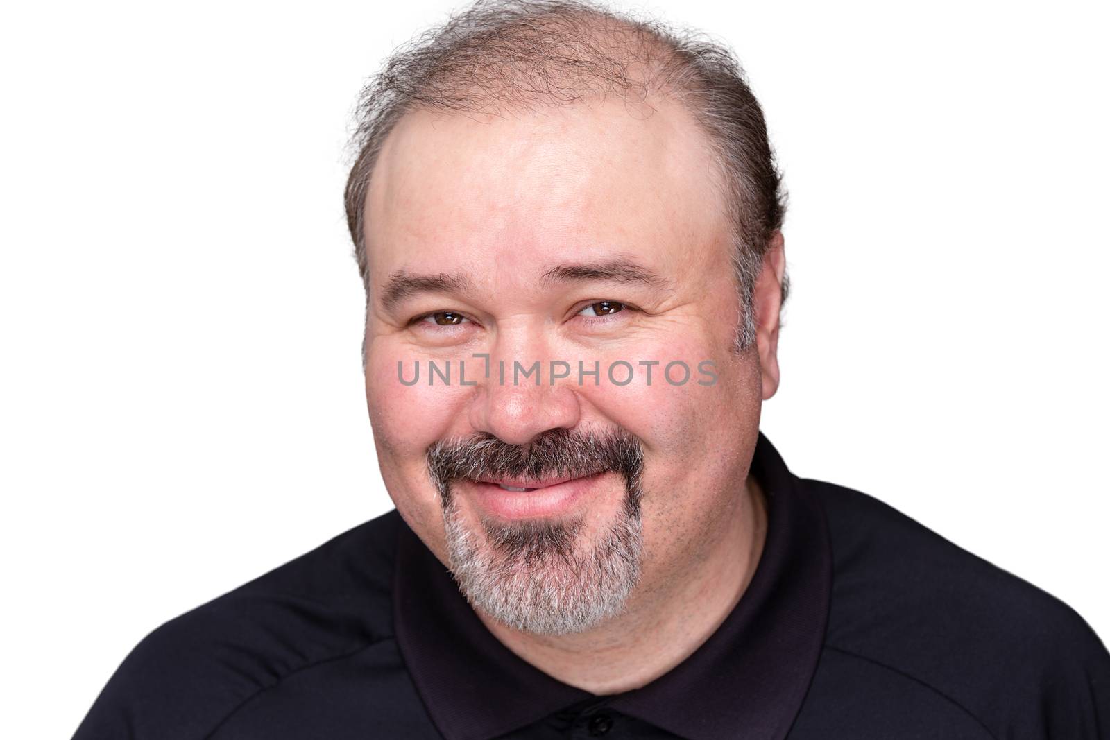 Smiling genial middle-aged man with a jovial expression beaming at the camera, head and shoulders isolated on white