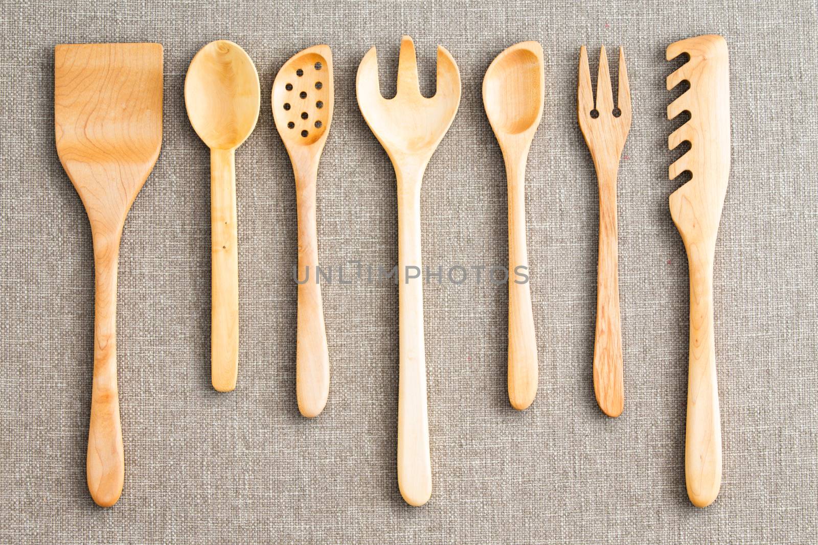 Row of assorted wooden kitchen utensils by coskun