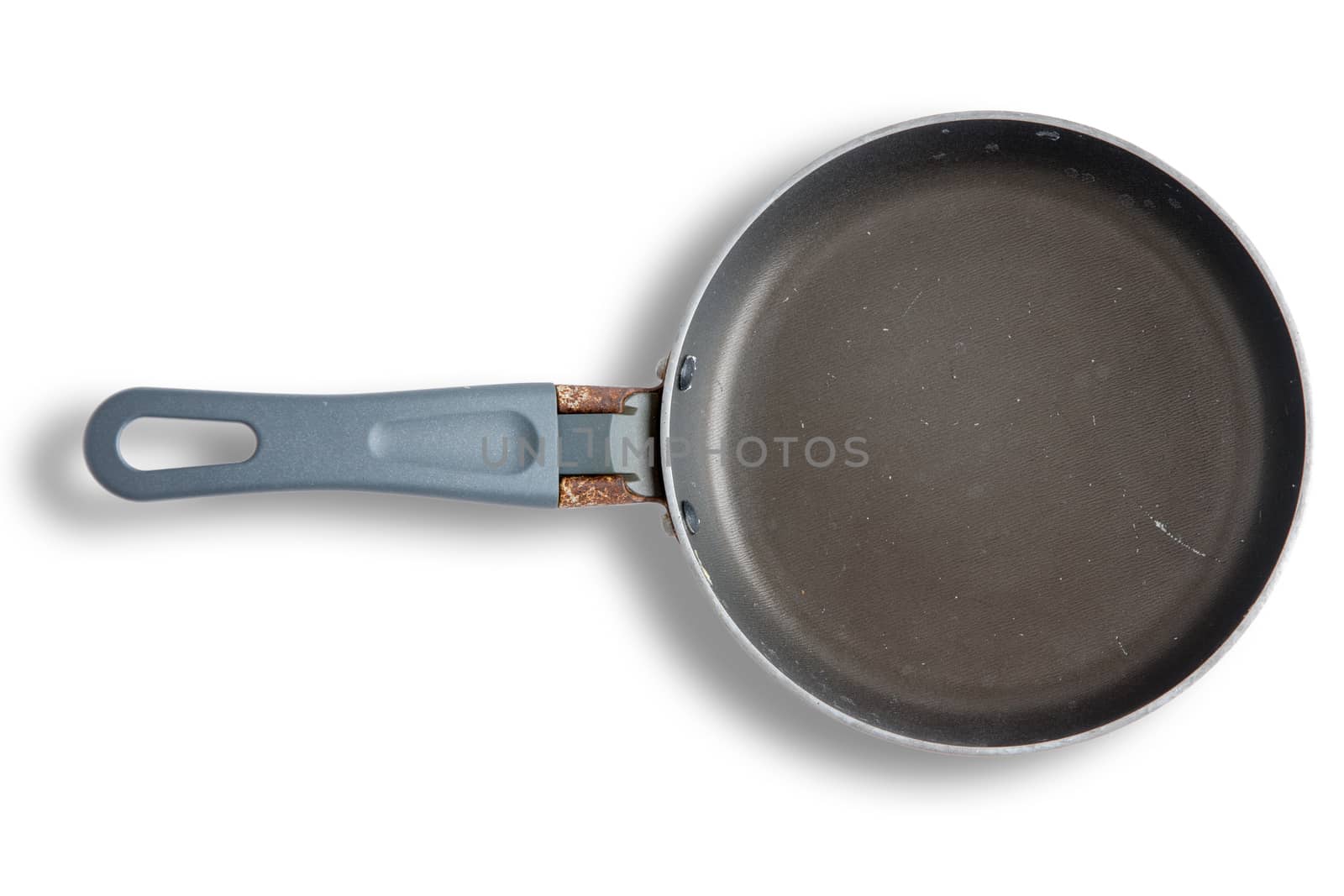 Old rusty empty small frying pan showing corrosion on the handle viewed from above on a white background