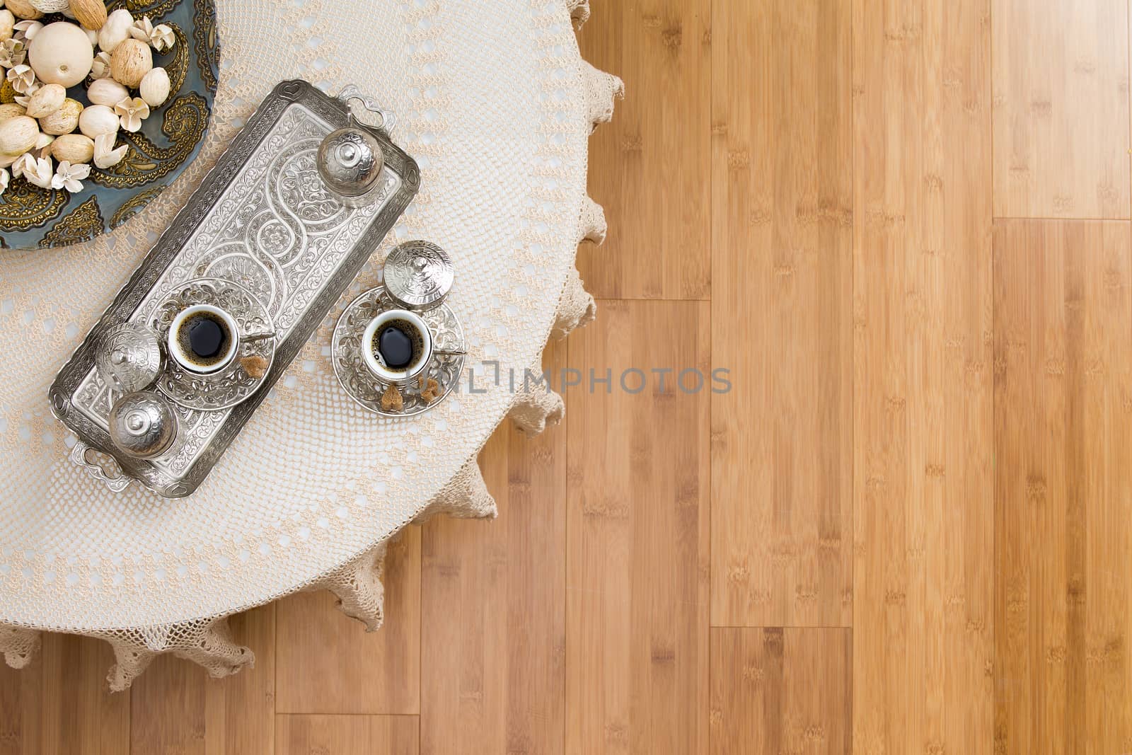 High Angle View of Turkish Coffee for Two Placed on White Table on a Wooden Floor, Emphasizing Texts Space.