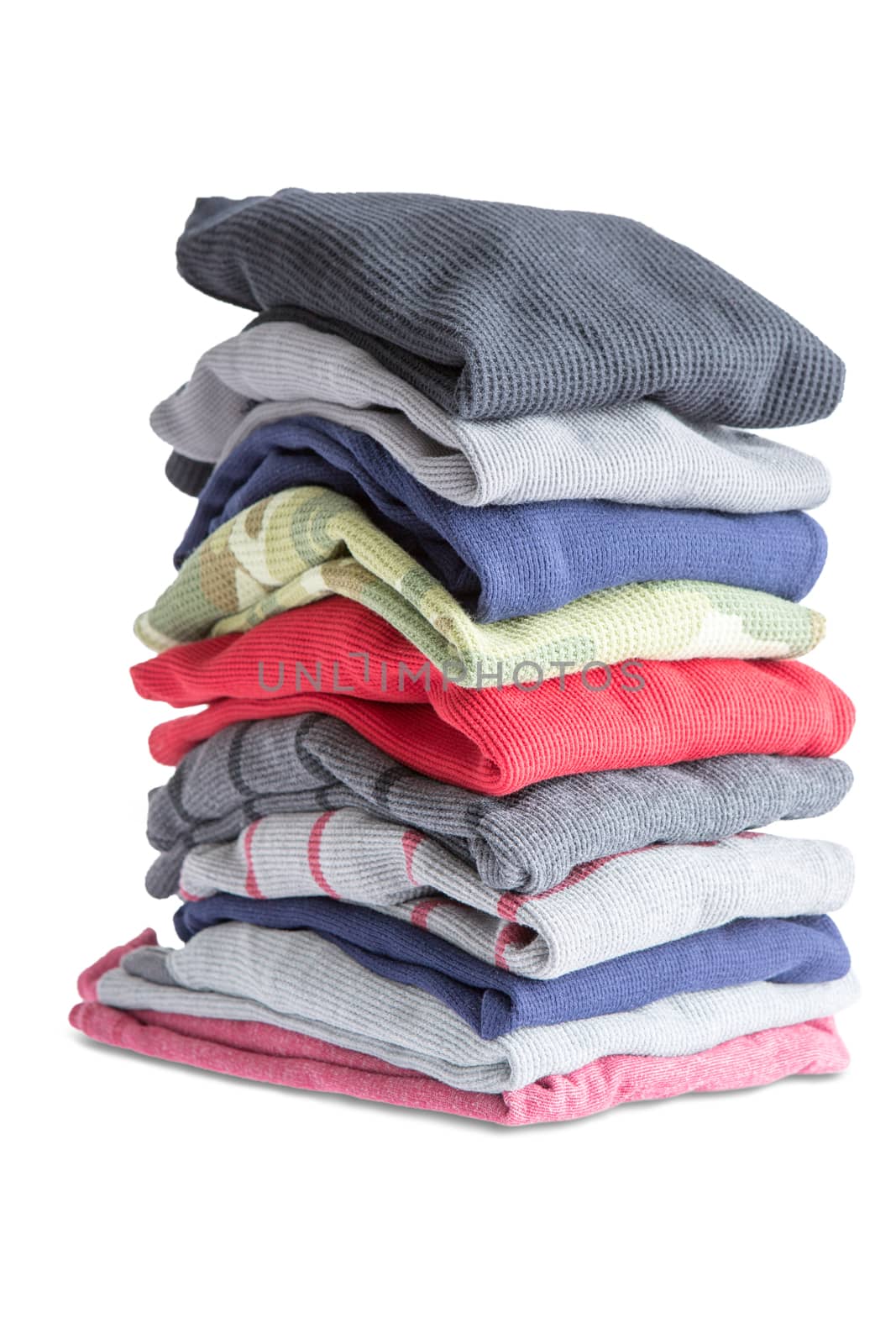 Close up Folded Assorted Clean Clothes in One Pile Isolated on White Background
