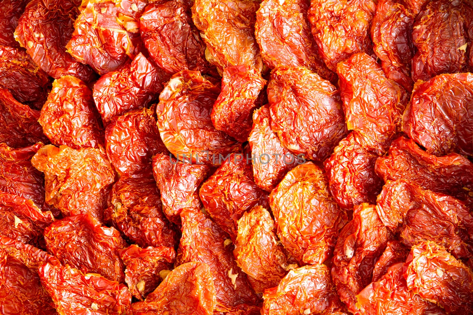 Background texture of neatly arranged ripe red sundried tomatoes, a healthy snack and appetizer rich in antioxidants and vitamins