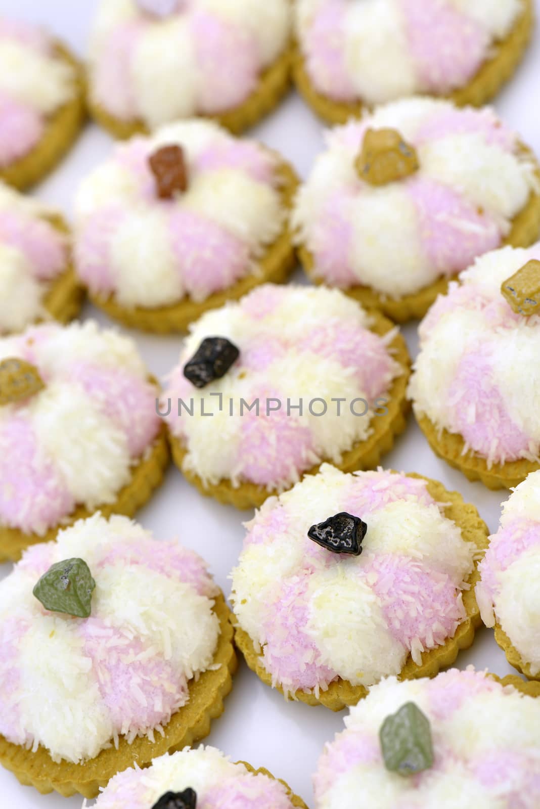 Several coconut cookies with chocolate stripes decorated with chocolate pebble