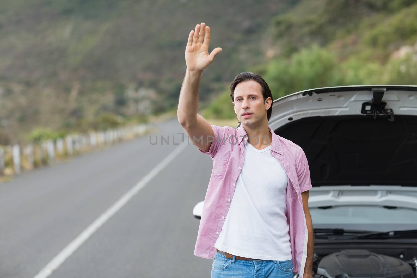Man waving after a breakdown at the side of the road