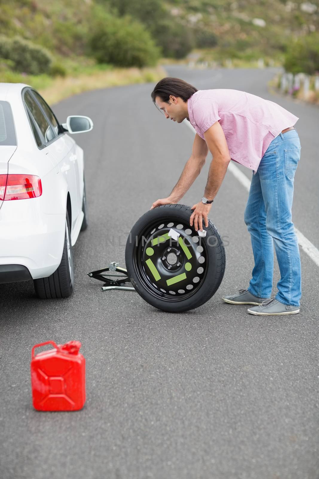 Man changing wheel after a car breakdown  by Wavebreakmedia