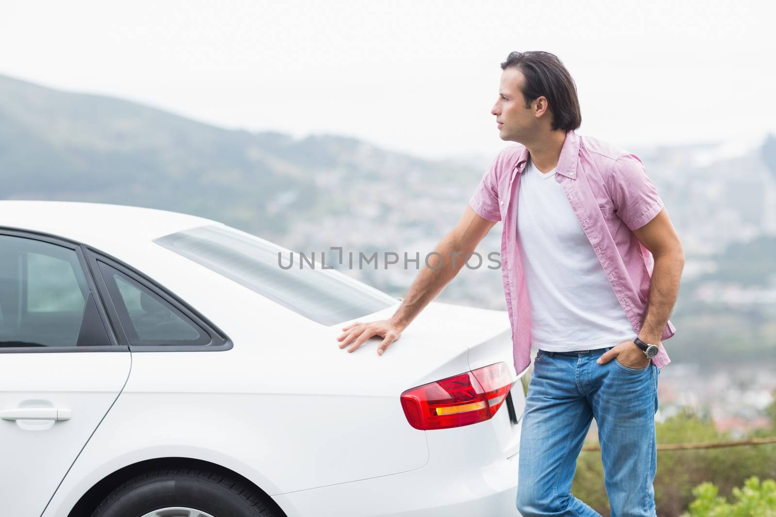Man standing next to his car at the side of the road