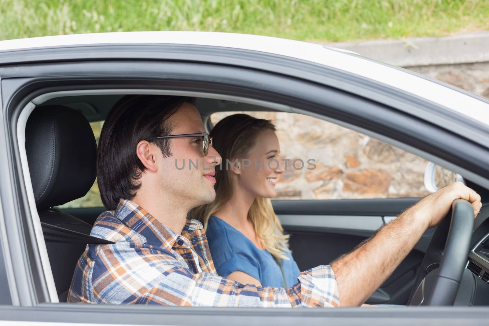 Couple on a road trip in their car