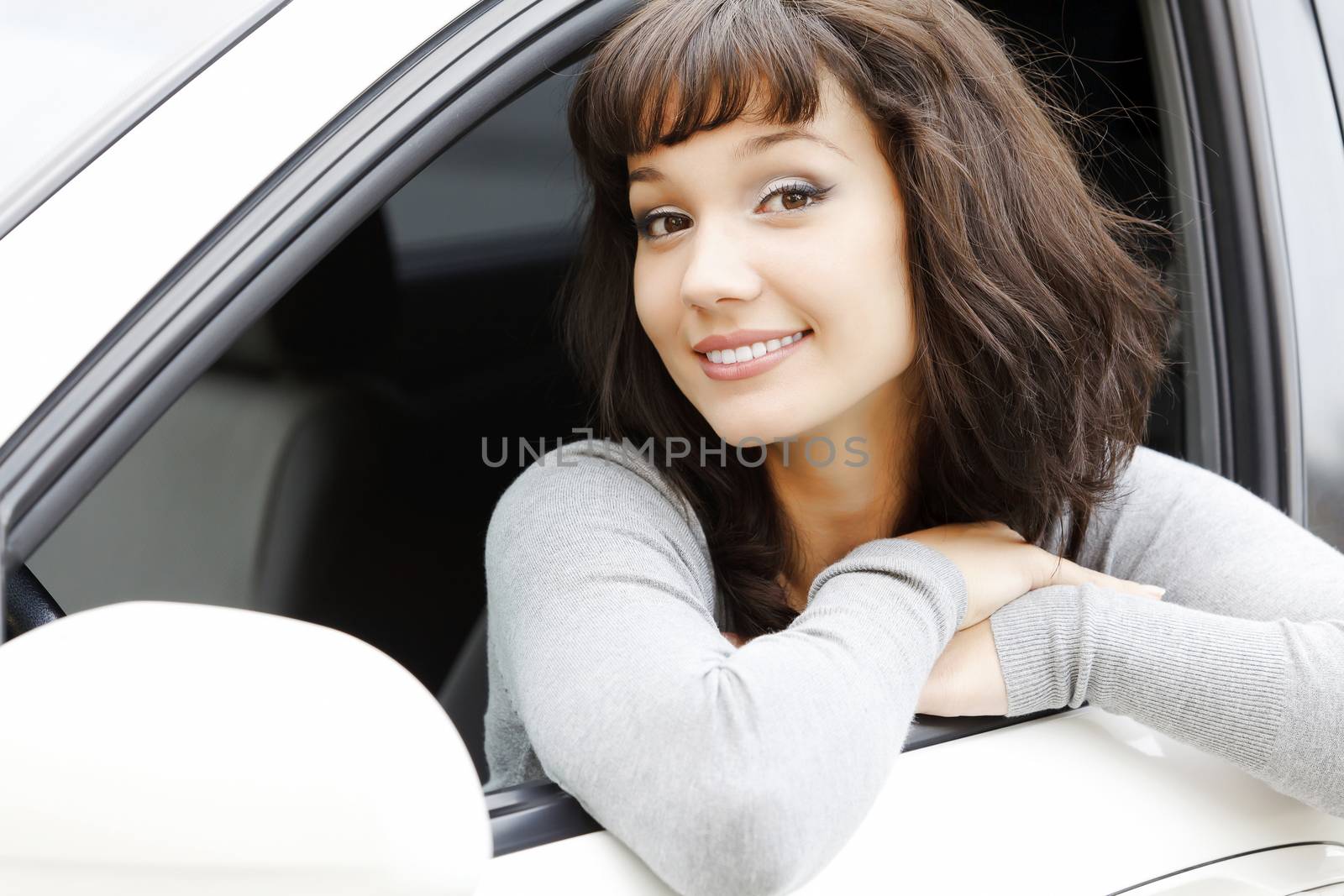 Pretty asian girl in a white car