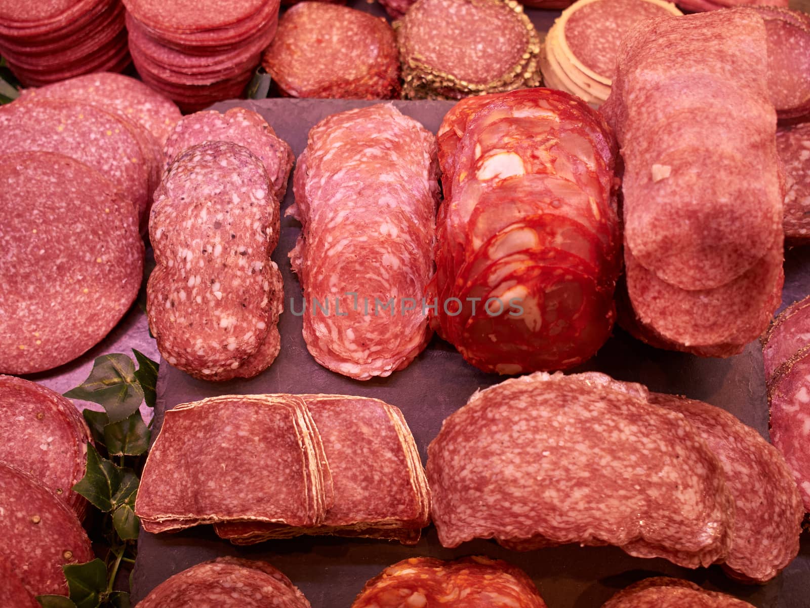 Closeup of a selection of freshly cut salami in a butcher shop