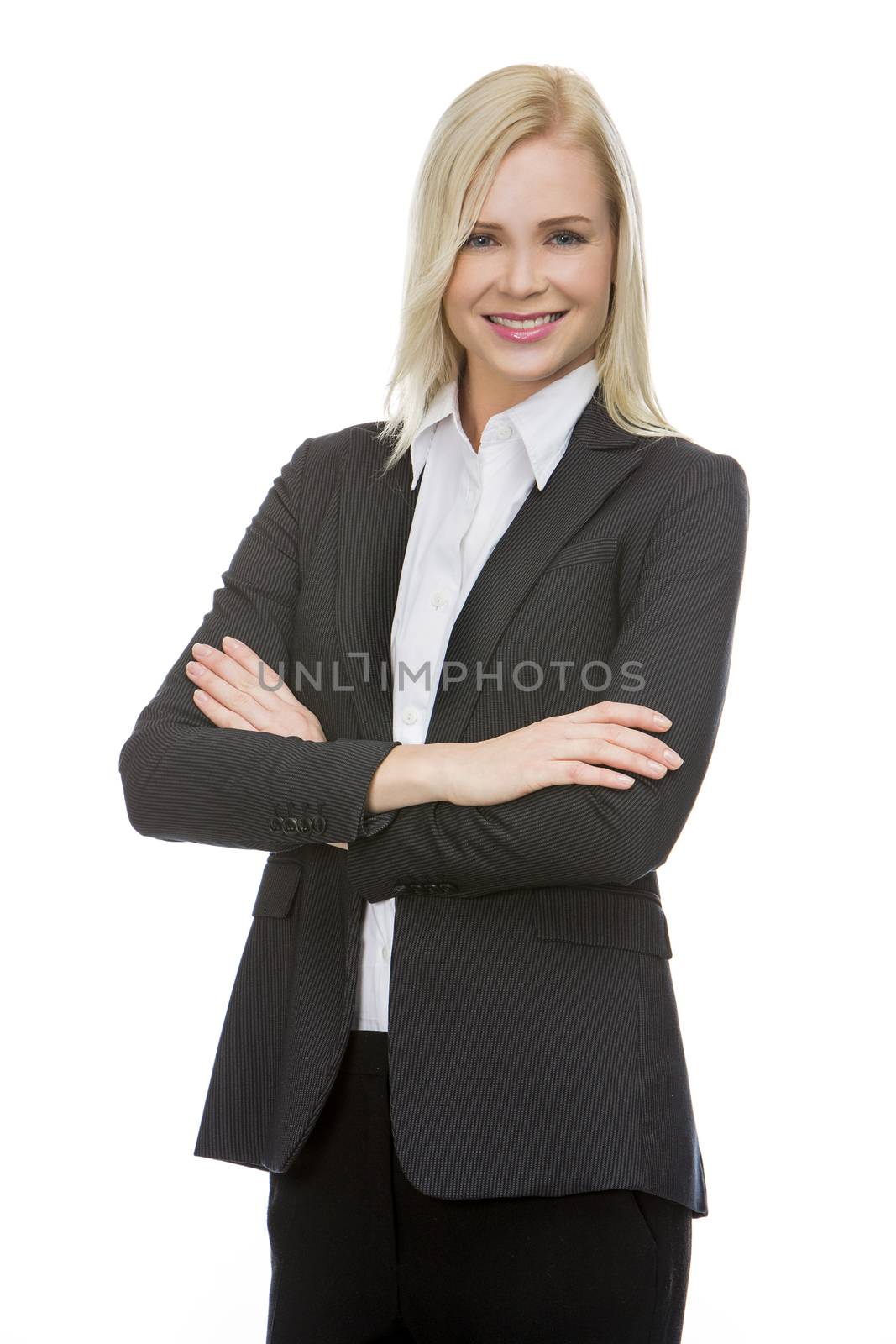 blonde businesswoman with her arms folded smiling at the camera