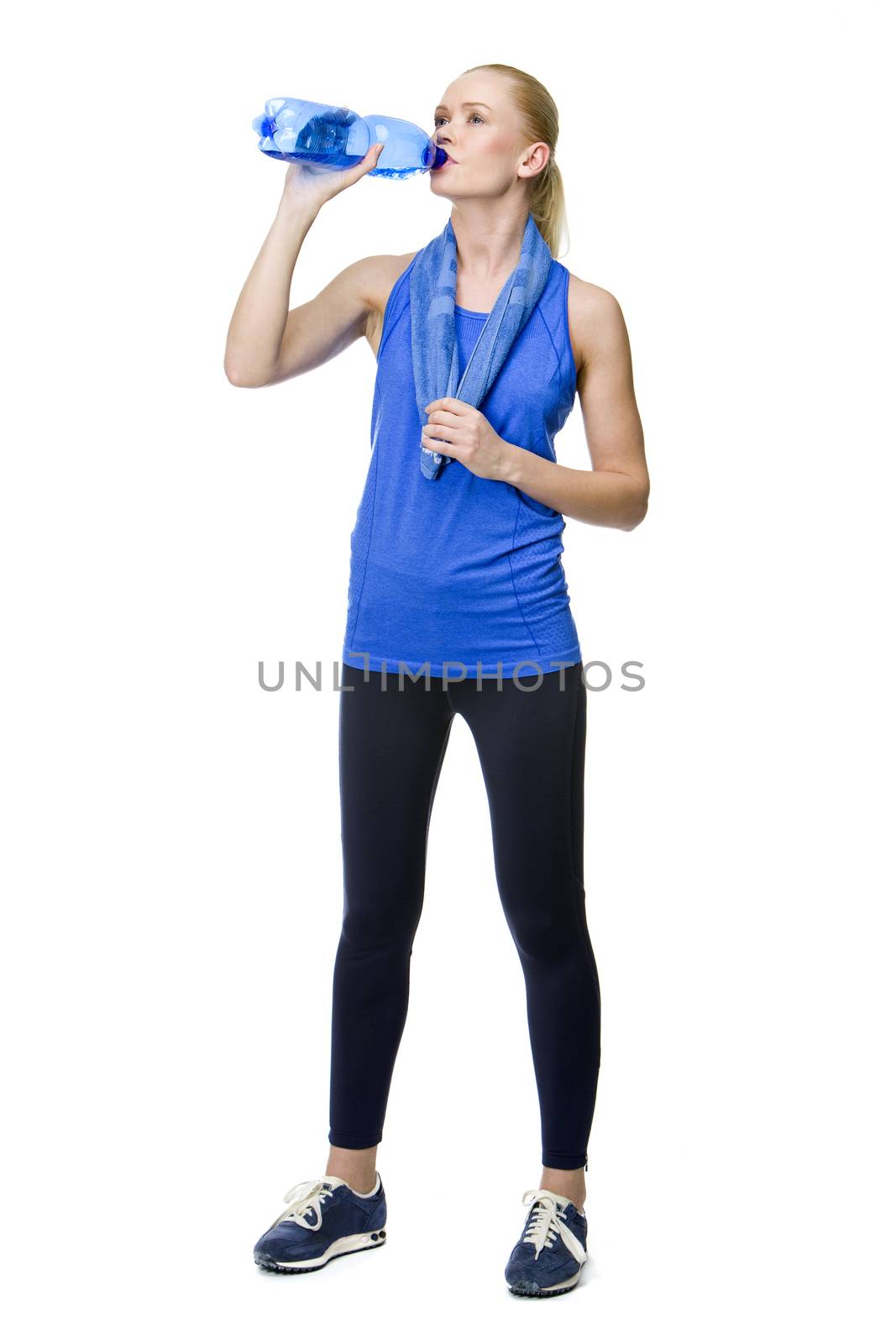woman in fitness clothing drinking by Flareimage