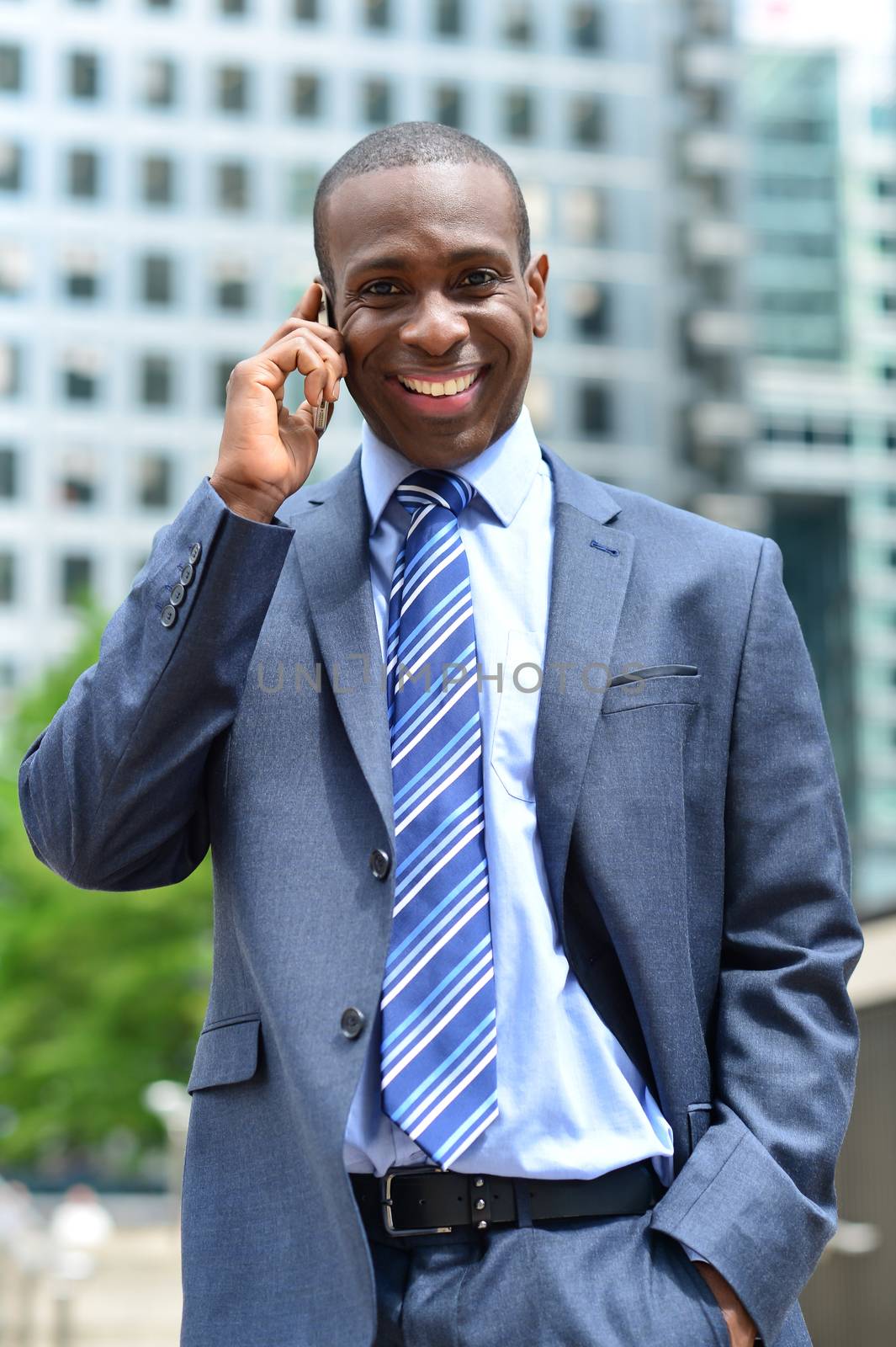 Businessman on the phone outside office building