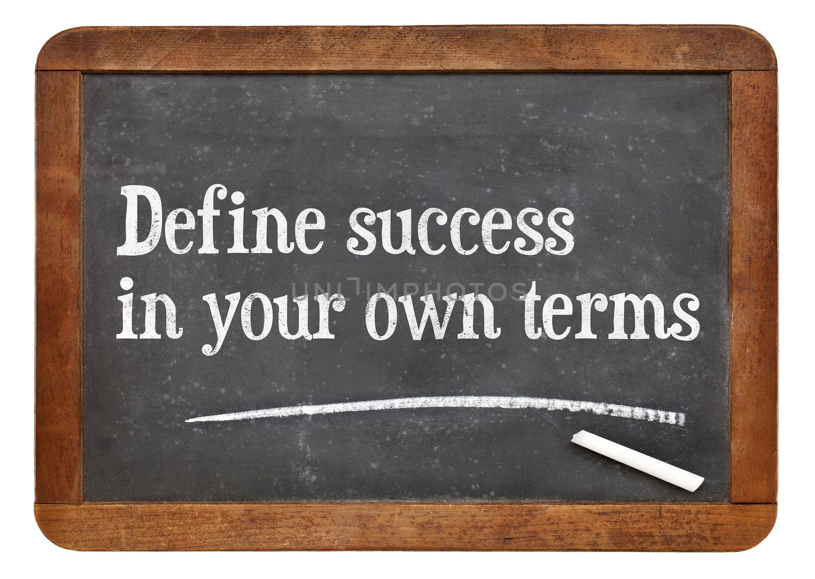 Define success in your own terms - inspirational words on a vintage slate blackboard