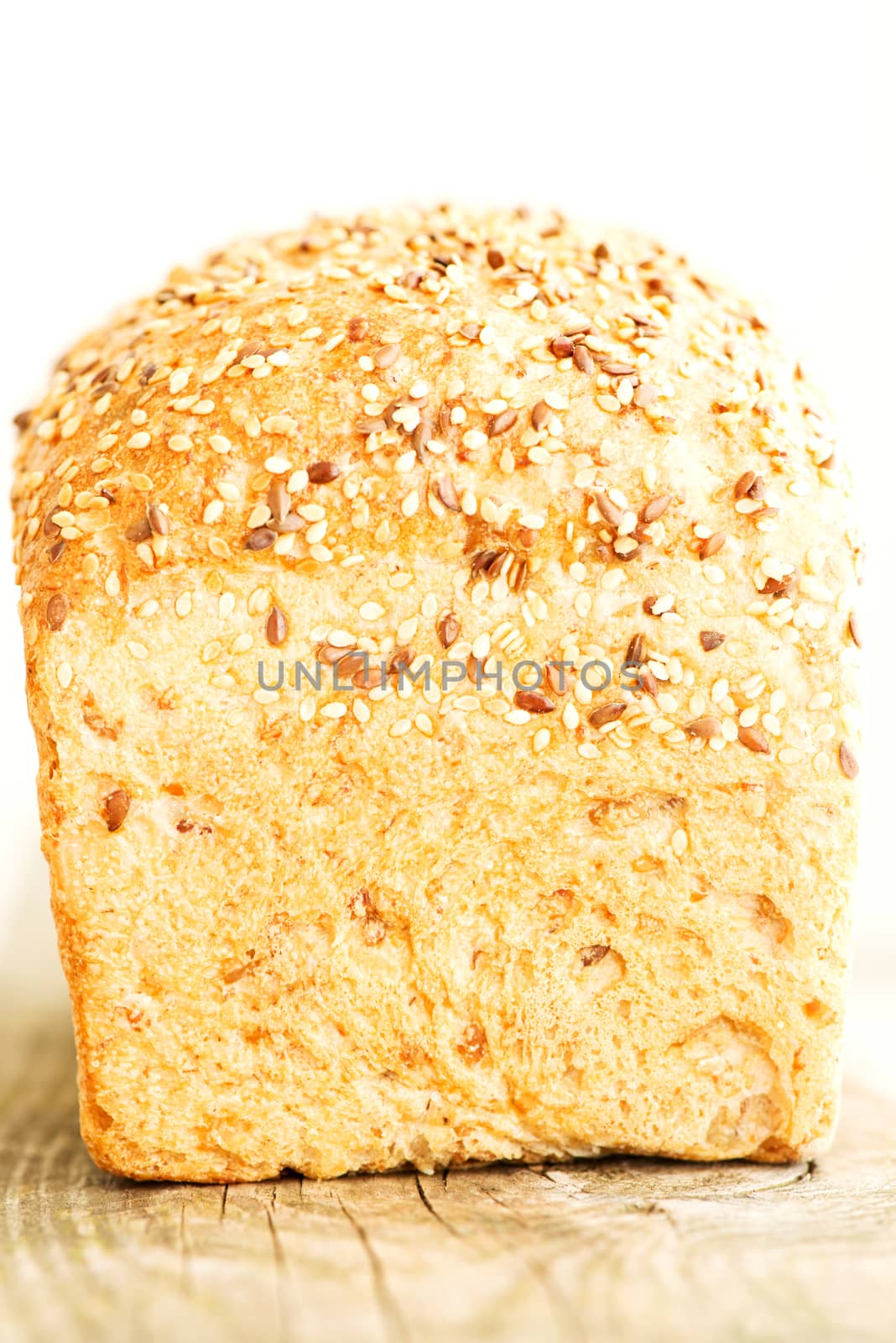 Loaf of bread on wooden table close up by Nanisimova