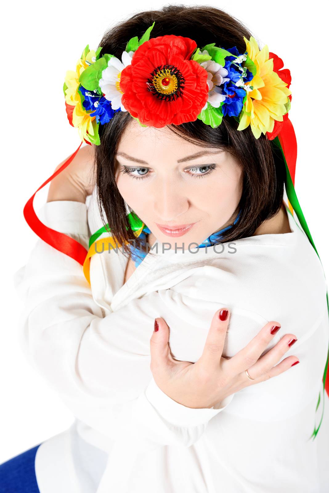 beautiful young brunette woman wearing national ukrainian clothes posing in studio on white background