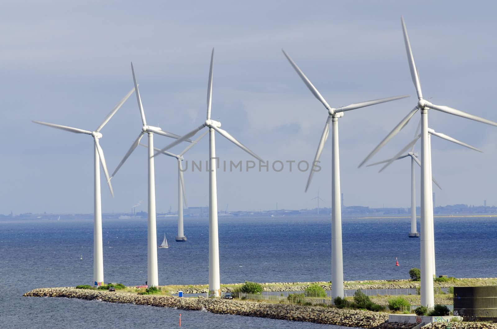 ind turbine generating electricity on sea by Nanisimova