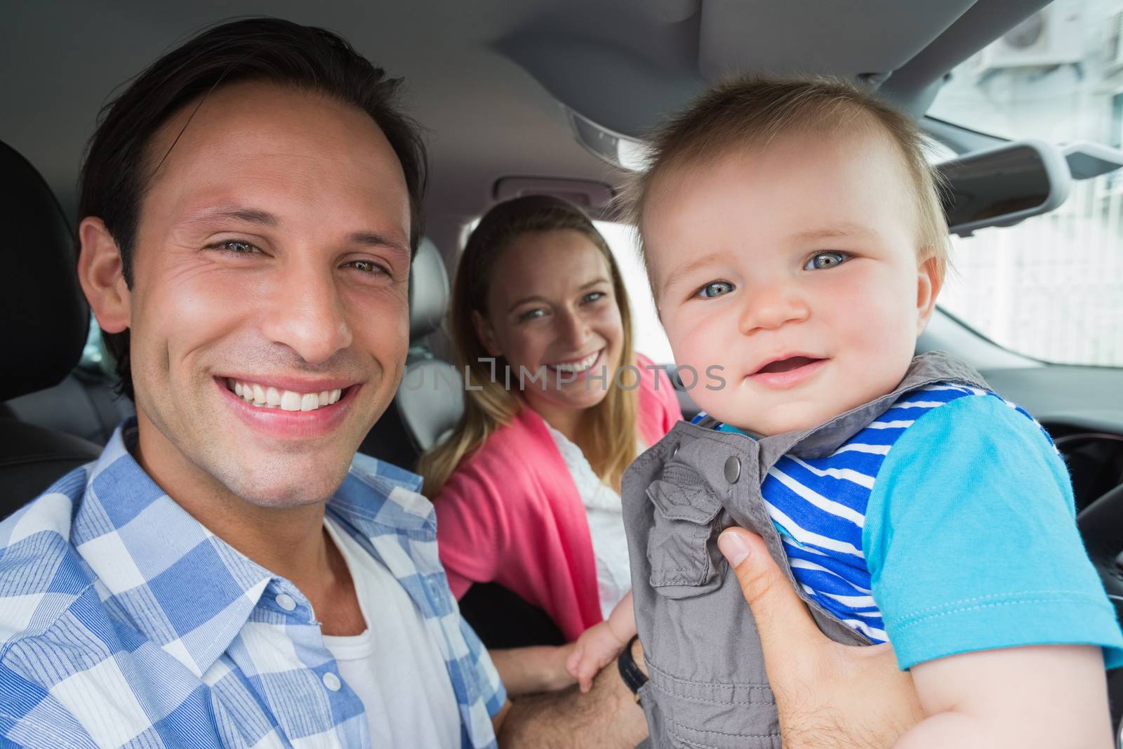 Parents and baby on a drive in their car