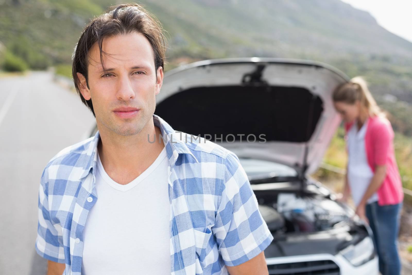 Couple after a car breakdown at the side of the road