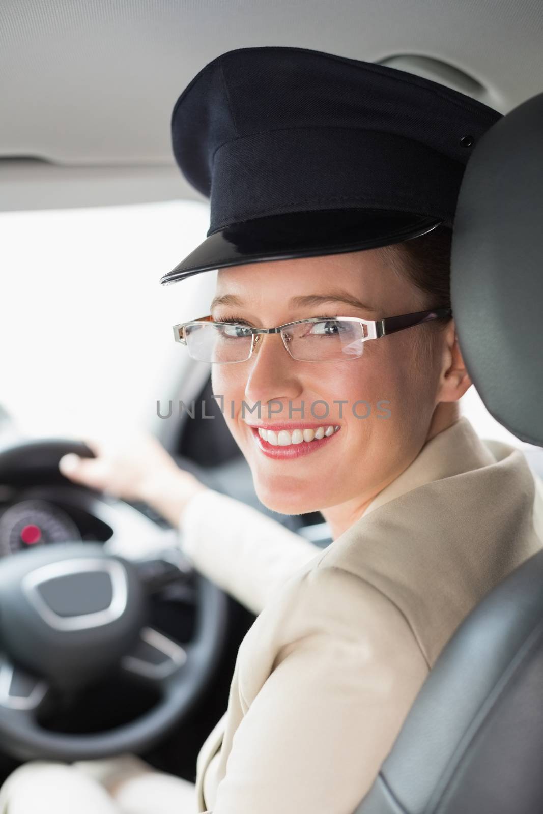 Chauffeur smiling at camera in the car
