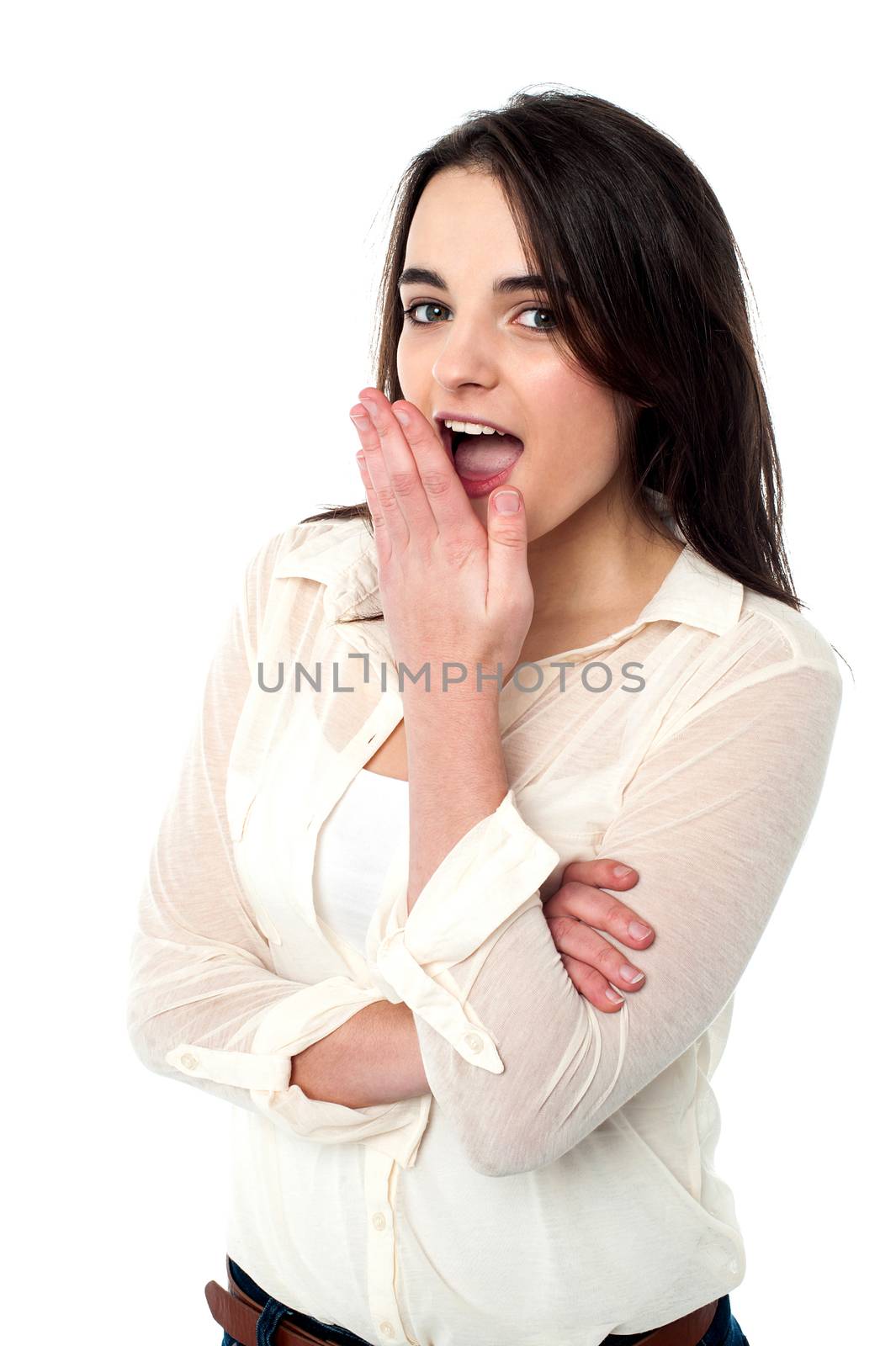 Joyous teen girl in casuals showing shocking sign to the camera.