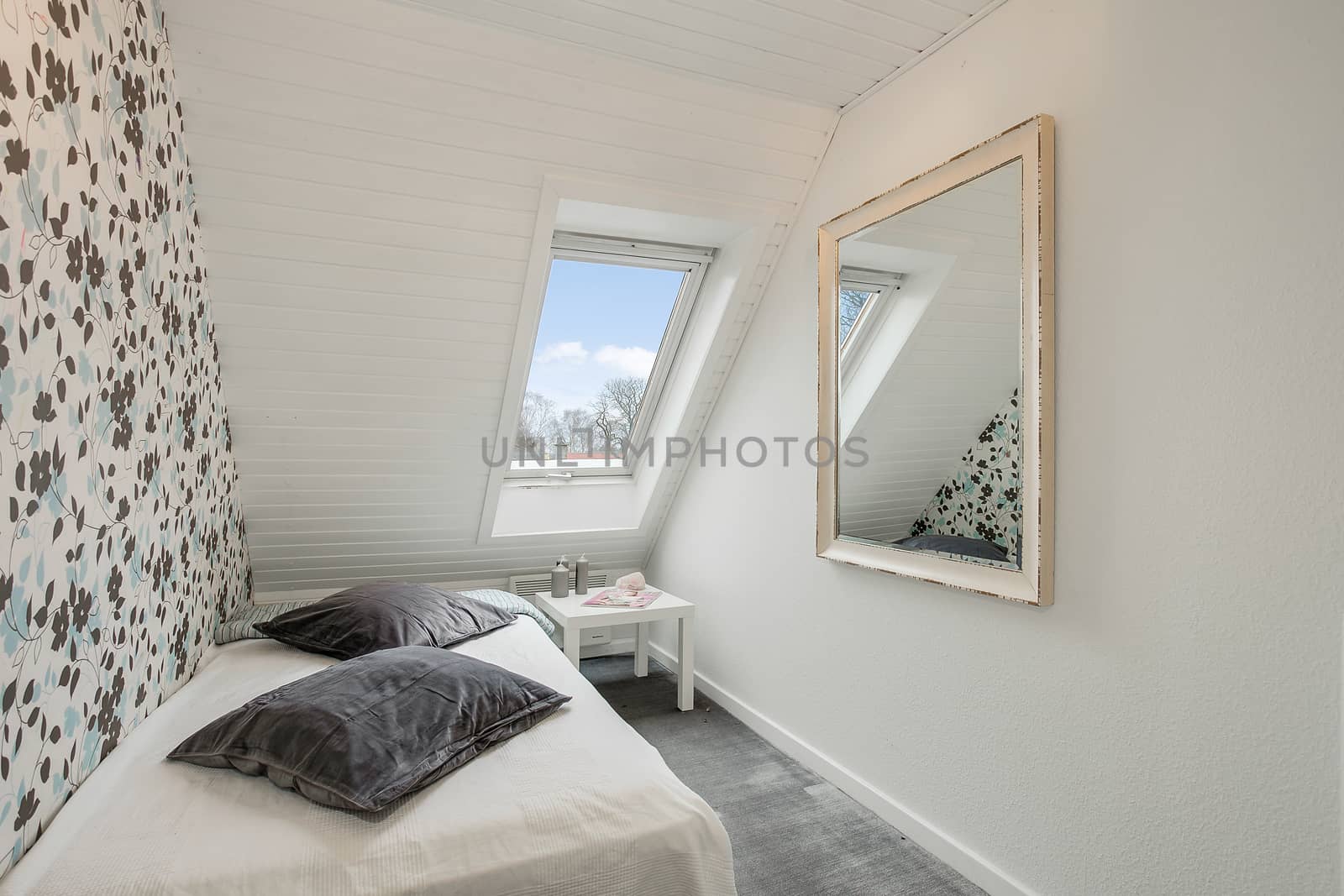 large mirror in a small bedroom in a Danish loft