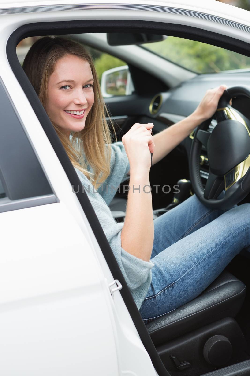 Young woman in the drivers seat  by Wavebreakmedia