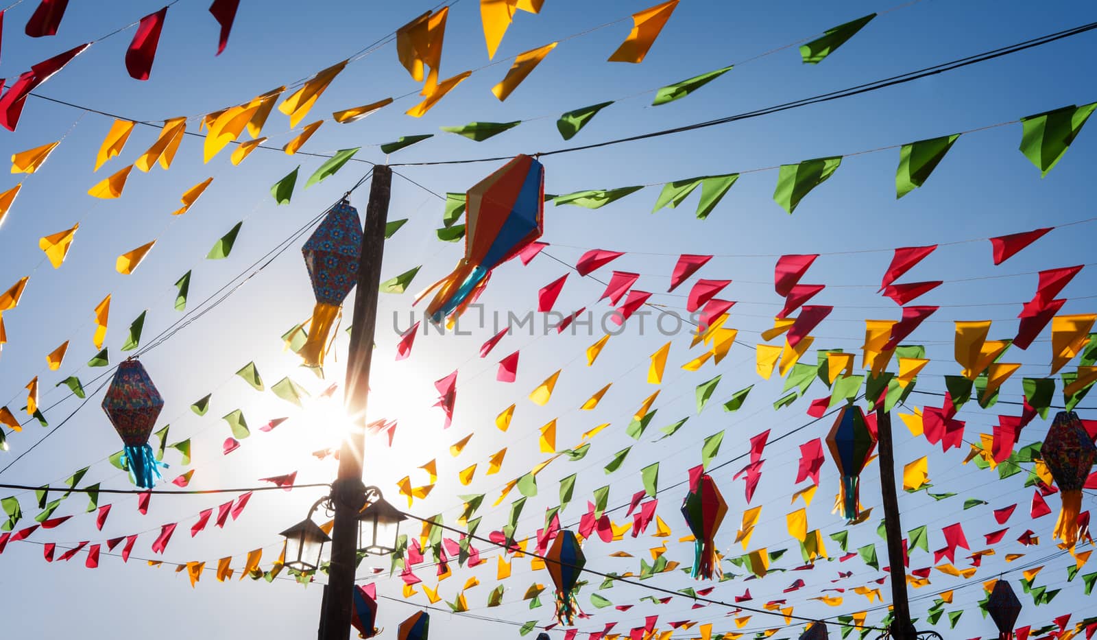 Bunting, colorful party flags, on a blue sky.