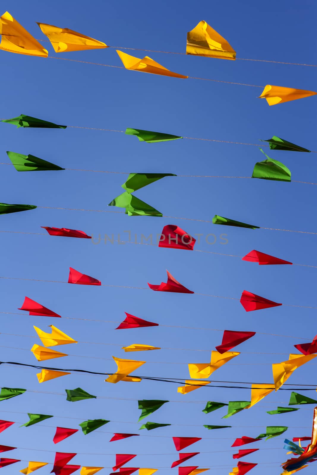 Bunting, colorful party flags, on a blue sky. by BrazilPhoto