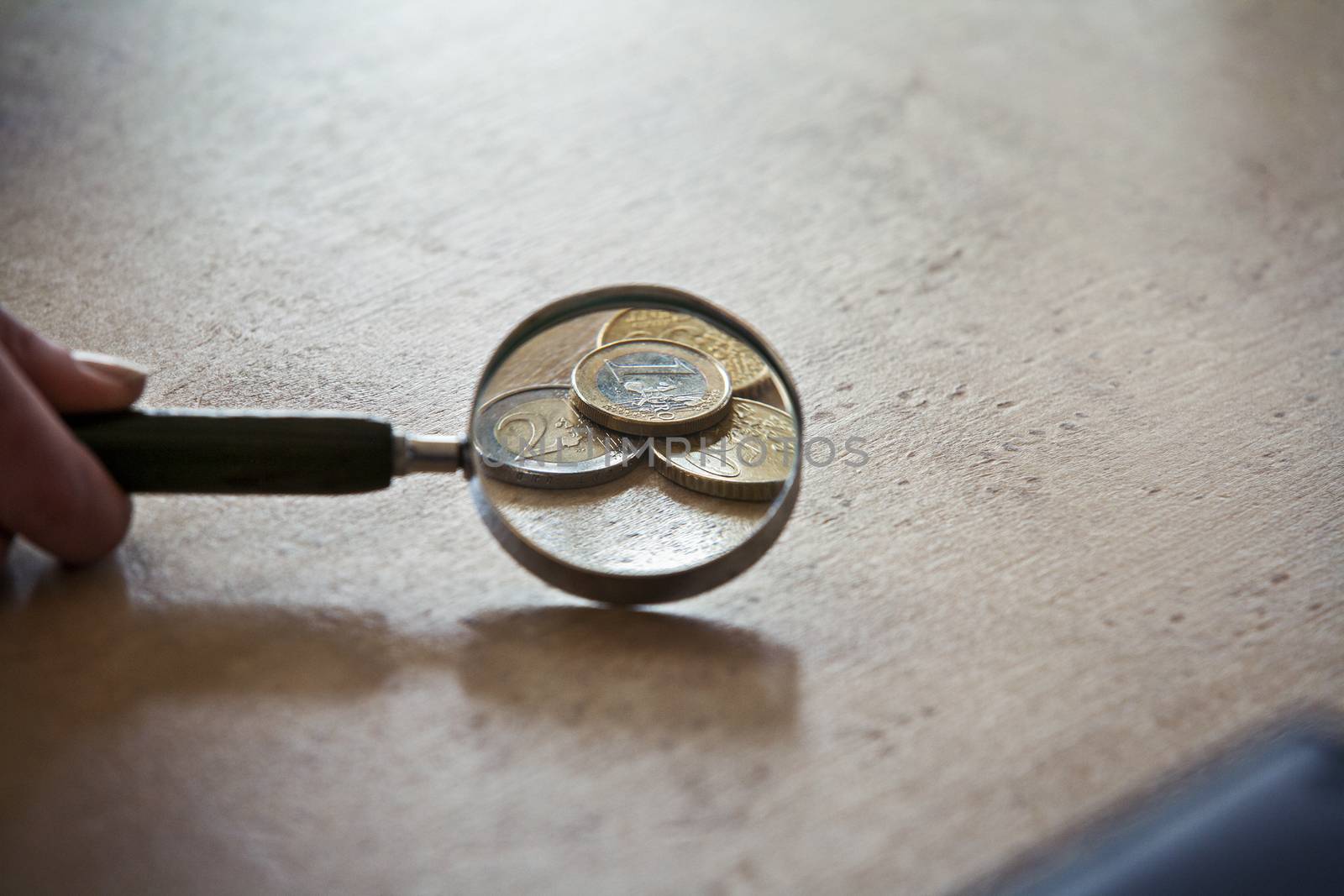 Magnifying Glass and euro coins.