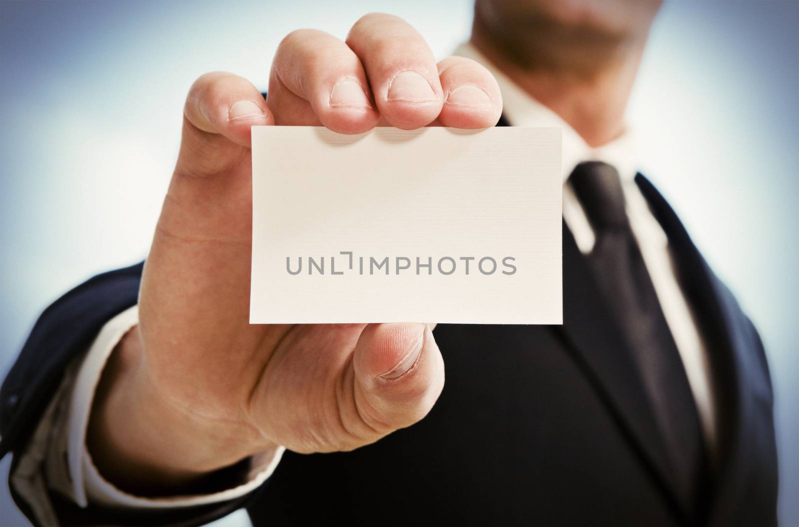 Man's hand showing business card by BrazilPhoto